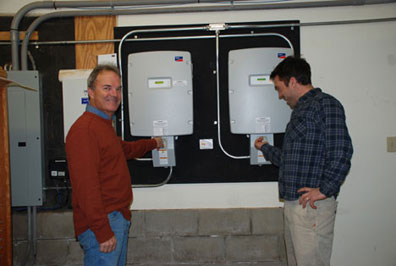 Bill and Saer Huston turn the switch, activating the solar array