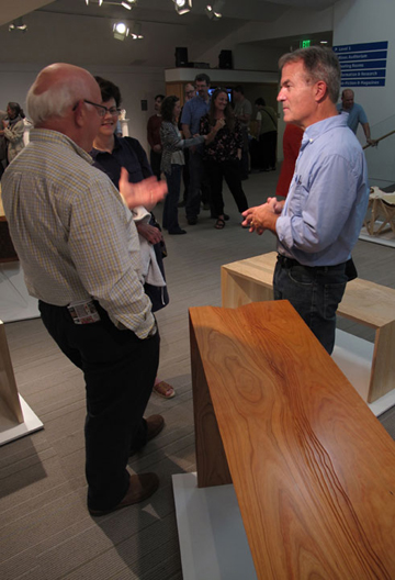 Bill Huston talks with exhibit visitors