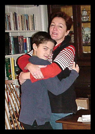 Collin presents his table to his mother, Mia, on Christmas Day 2002
