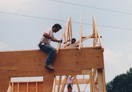 Bill Huston works on the trusses of his new workshop