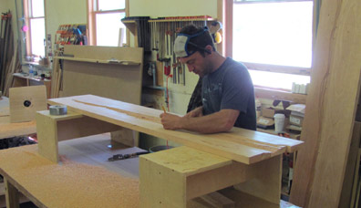 Saer Huston works on the headboard of the new Rivers Bed, Huston and Company