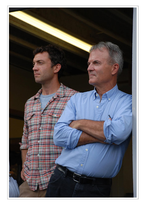 Saer and Bill Huston look on as Bill's brother, Bob, talks at the company's 25th anniversary.