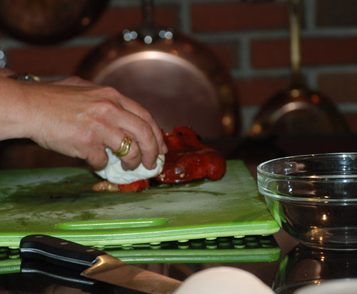 Jill Strauss prepares a roasted red pepper for class at Jillyanna's